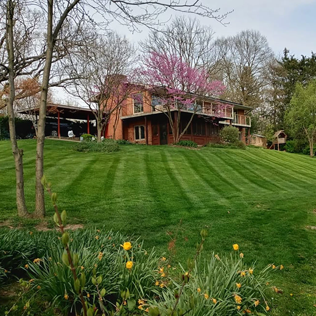 Mowed lawn for a home on a hill in Powell, OH.