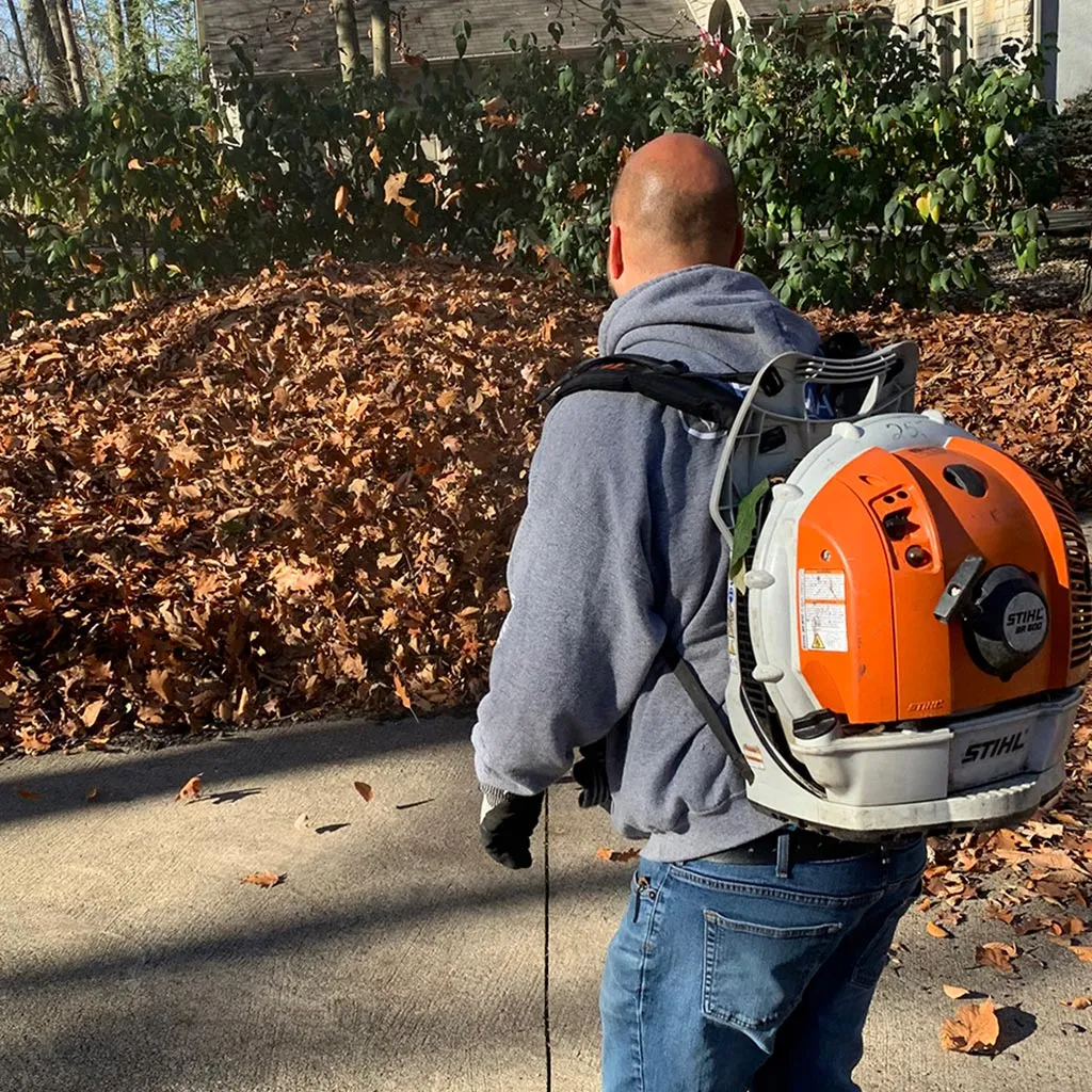 A professional leaf blowing a property in Powell, OH.