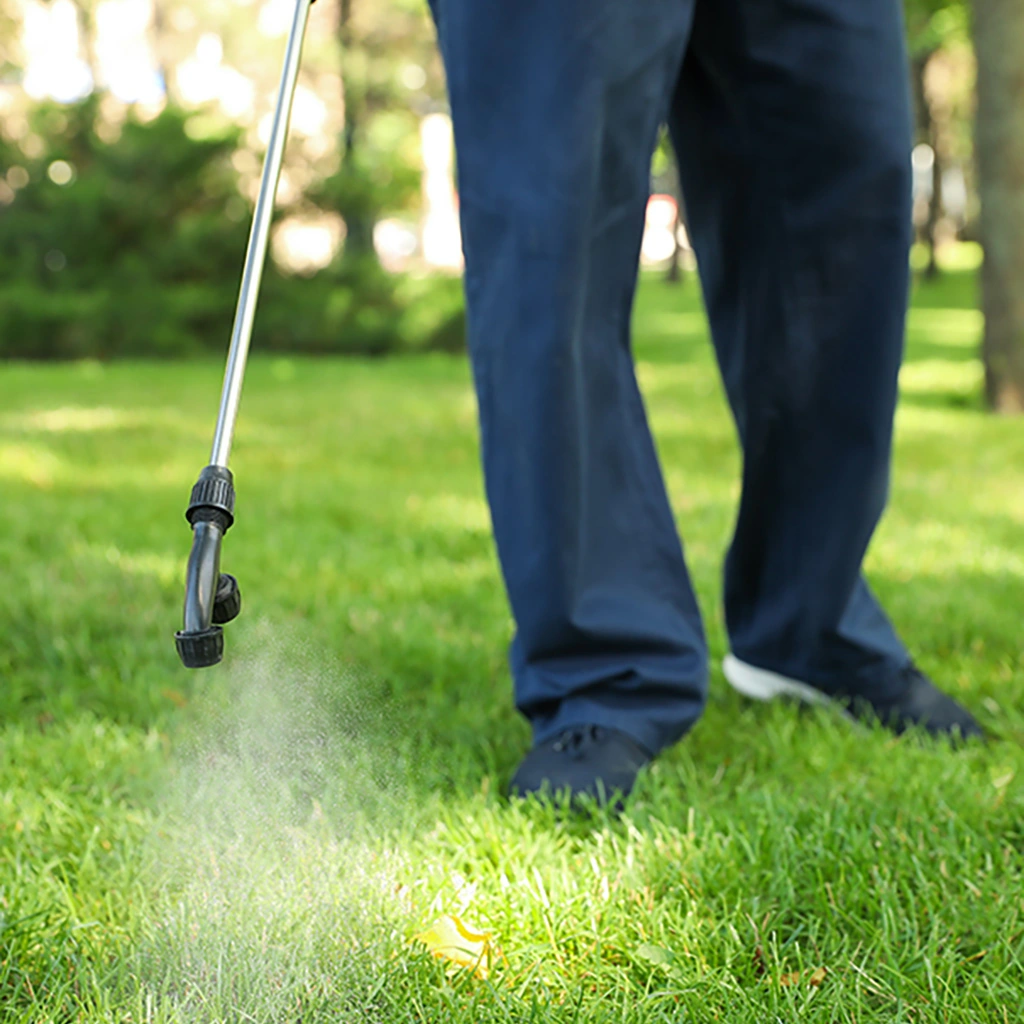 Professional applying weed control to a lawn in Lewis Center, OH.