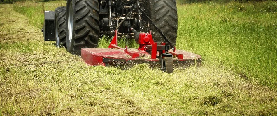 Brush hogger removing overgrown grass in Delaware, OH.
