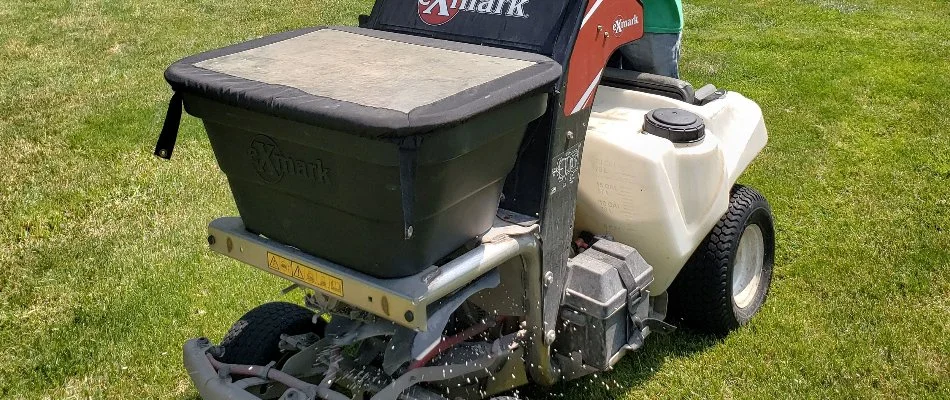 Granular fertilizer spreader machine on a lawn in Delaware, OH.