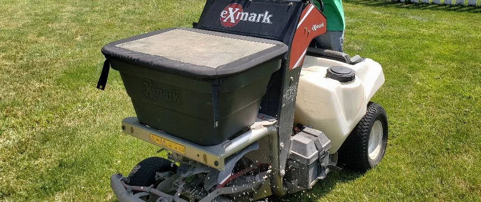 Lawn in Delaware, OH, with granular fertilizer spreader machine.