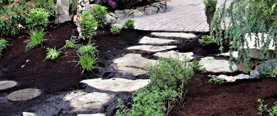 Mulched landscape bed with plants around a walkway in Delaware, OH.