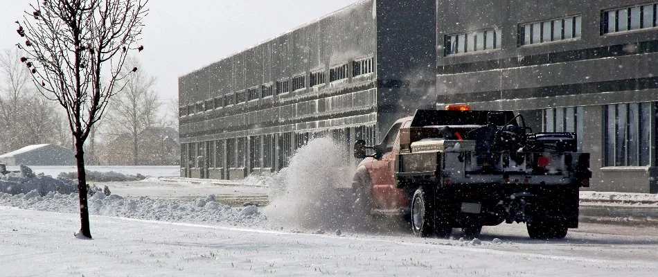 Plow truck removing snow outside a commercial building in Delaware, OH.