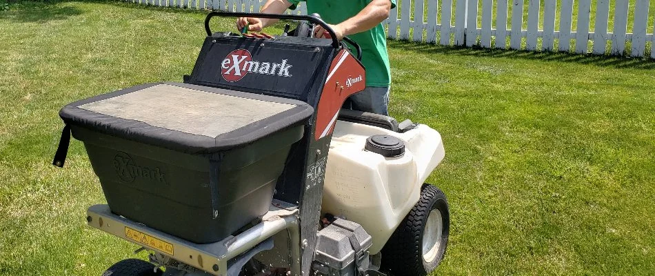 Professional fertilizing a lawn in Delaware, OH.