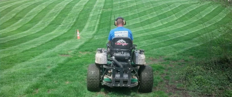 Professional on a mower mowing a lawn in Delaware, OH.