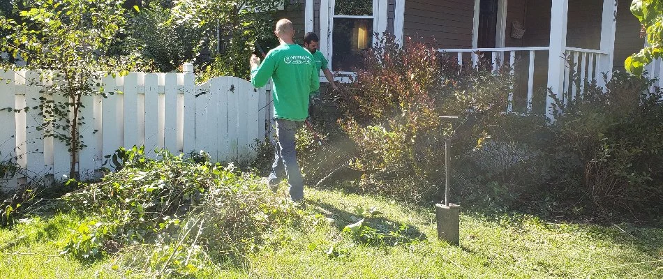 Professionals in Delaware, OH, removing debris from a yard.