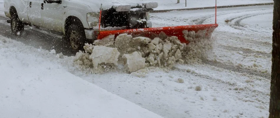 Snow plow removing snow from a road in Delaware, OH.