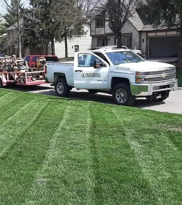 Hoffmans Lawn & Fertilization service truck at a home in Ostrander, OH.