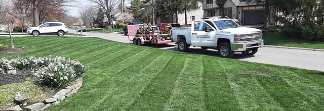 Hoffmans Lawn & Fertilization work truck at a home in Delaware, OH.