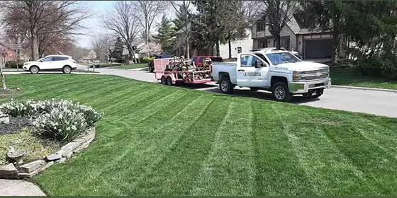 Hoffmans Lawn & Fertilization service truck by a lawn in Delaware, Ohio.