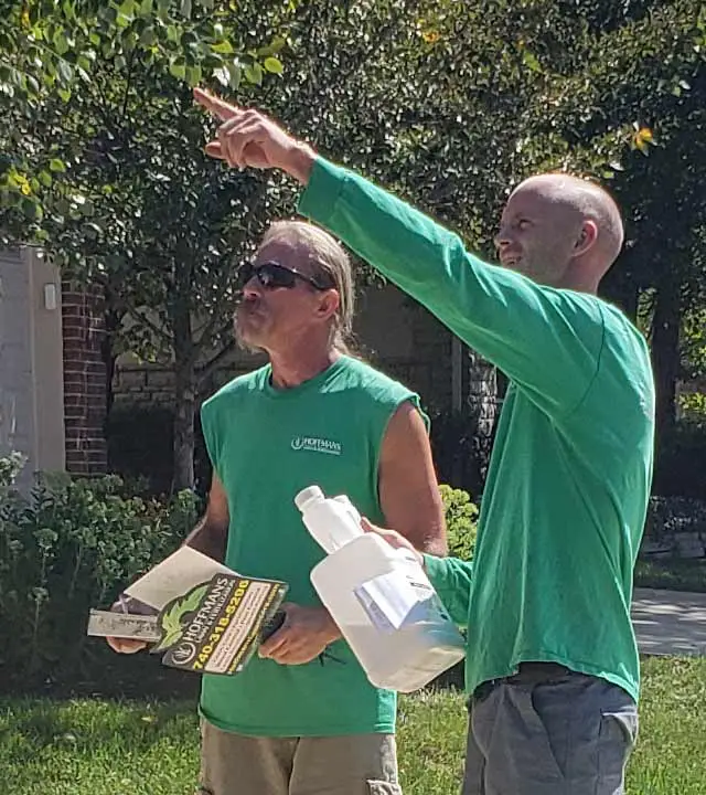 Lawn care workers discussing a job in Sunbury, Ohio.