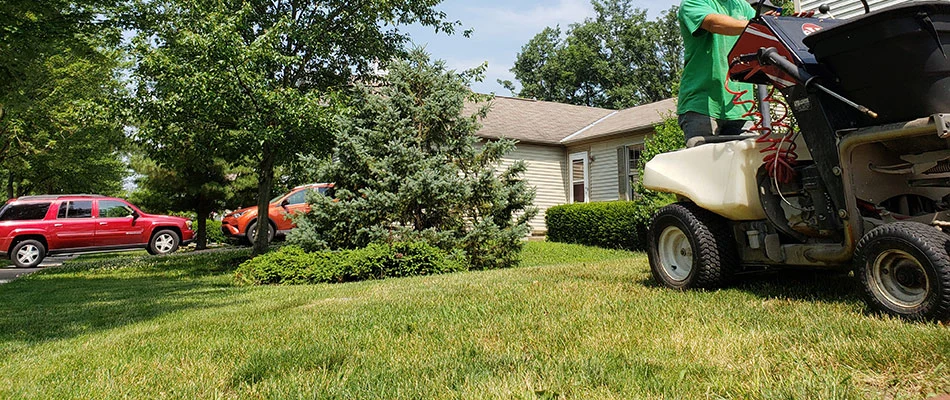 Professional servicing lawn with a machine in Delaware, OH.