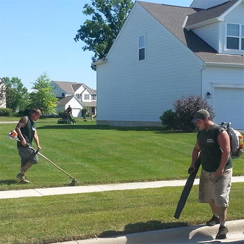 String-trimming, lawn mowing, and clearing debris with a leaf blower near Delaware, OH.