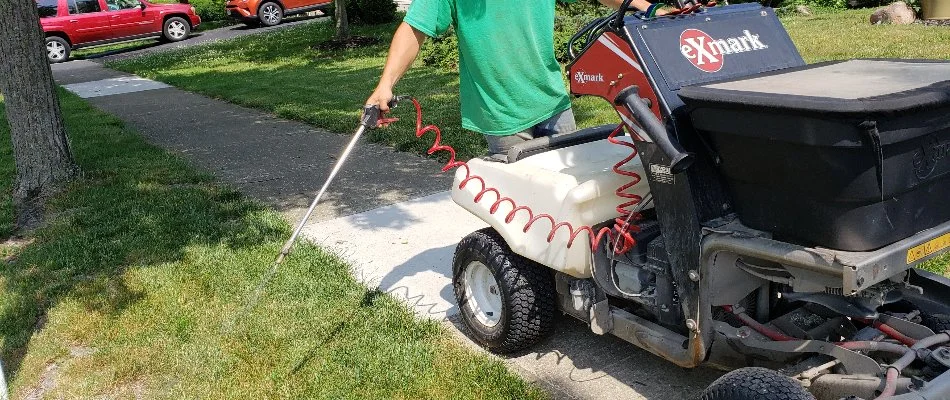 Tech spraying treatment on grass in Amlin, OH.