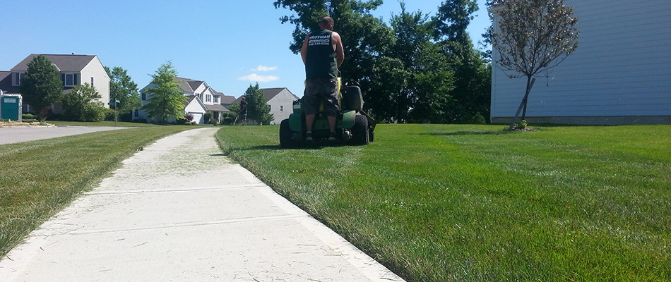 A technician mowing a lawn in Powell, OH.