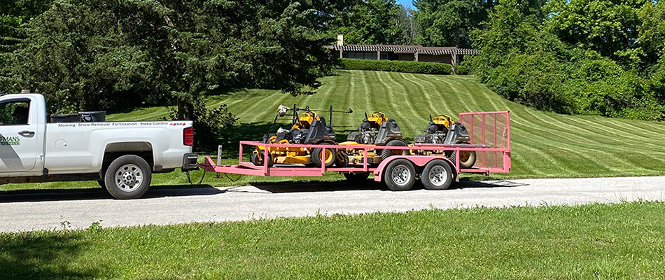Work equipment on a work trailer in front of mowed lawn in Powell, OH.